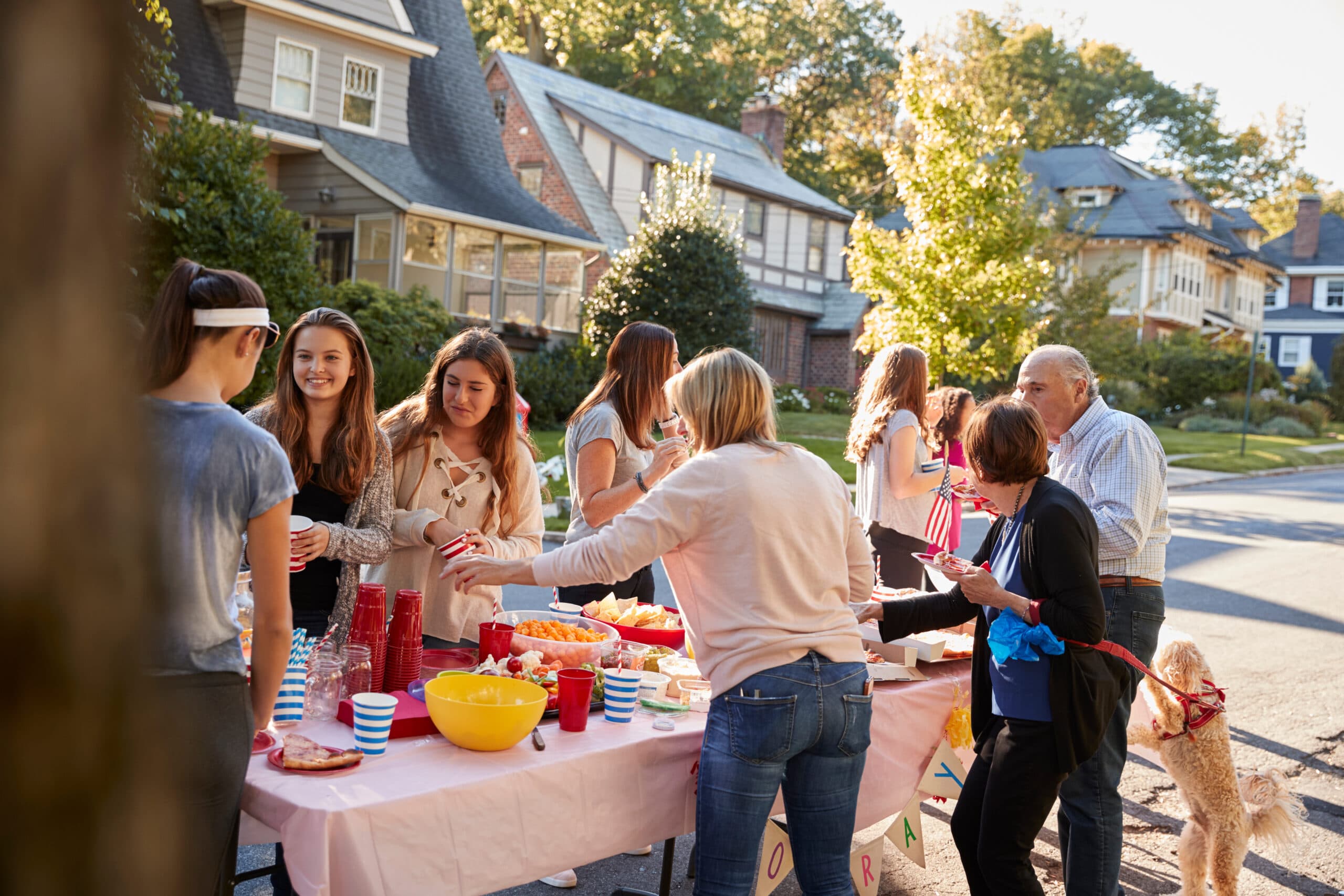 Neighbors talking around a table at a block party