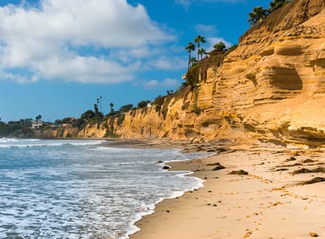 Sunlit cliffs and surf on the Southern California coast