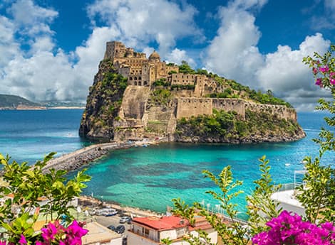 The Aragonese castle and turquoise bay on the island of Ischia, Italy